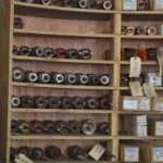 Wooden shelving unit displaying various automotive bearings and electrical components in different sizes and colors
