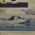 Aqua Lung Racing hydroplane boat numbered 007 driven by Kathy & Jim Buesse on water with spray