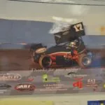 Race car number 17 with wings on indoor wall display, sponsor logos including McCulloch's RV and R&T Structures visible
